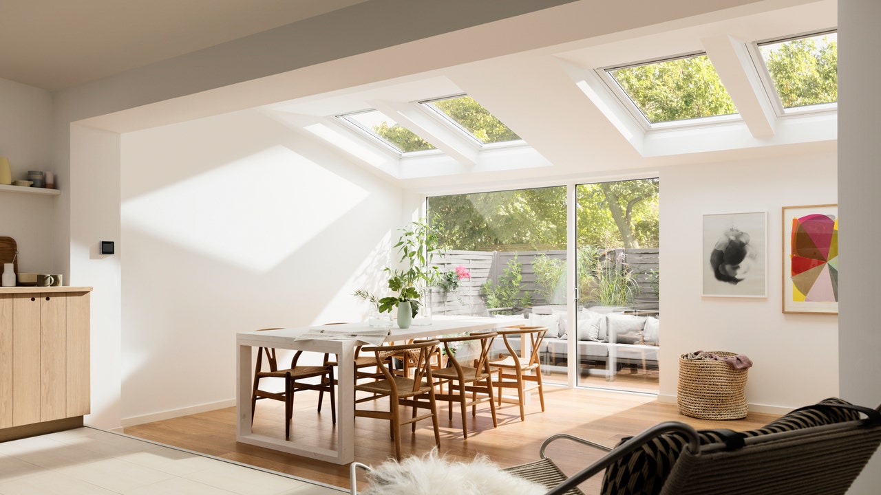 VELUX roof windows for kitchen or single storey extensions filling dining area with natural sunlight